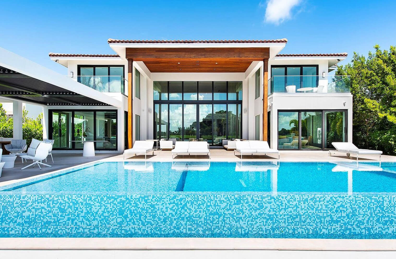 Shoreside featuring an infinity pool and sky in background