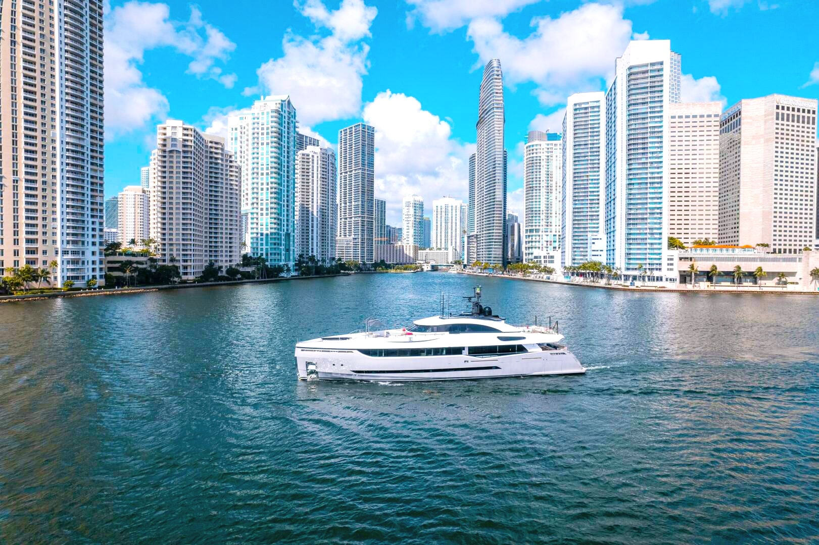 A yacht in the water under the Miami skyline